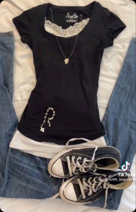 Black lace-trimmed t-shirt layered over a white shirt with blue jeans and black sneakers.