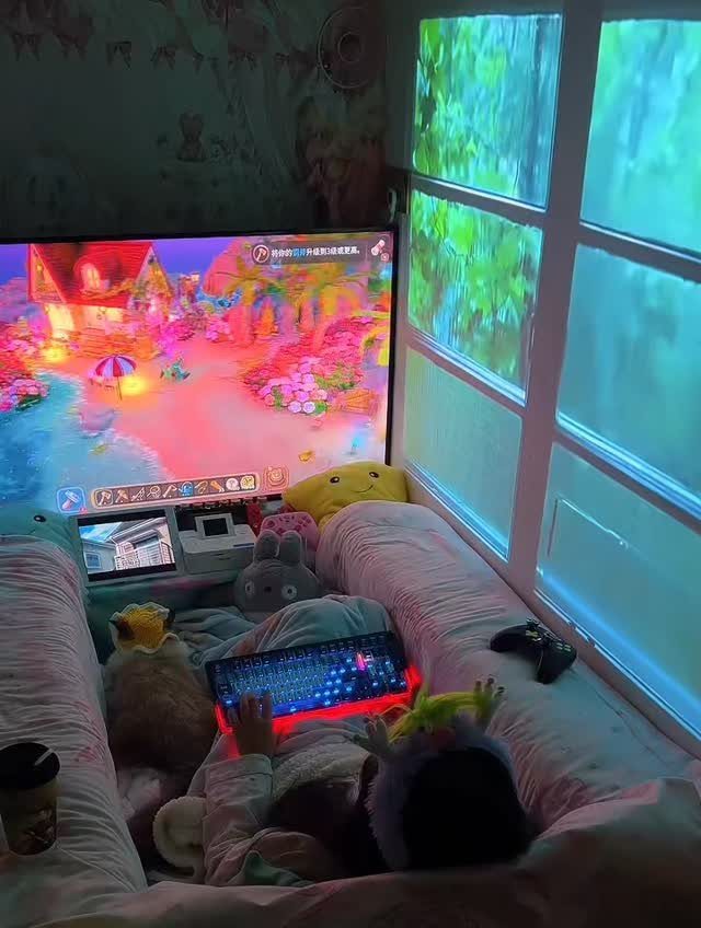 A person playing a colorful video game in a cozy window nook with plush toys.