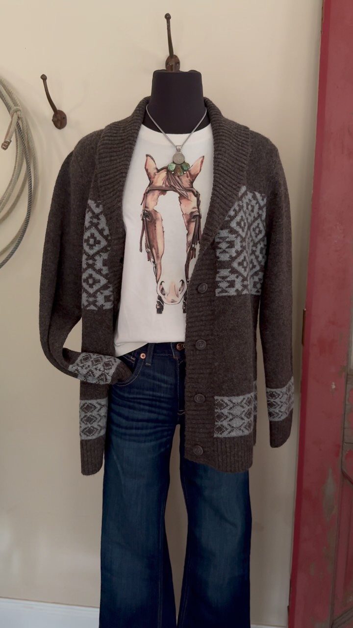 Mannequin wearing a Southwestern patterned knit cardigan, horse graphic tee, and flared blue jeans.