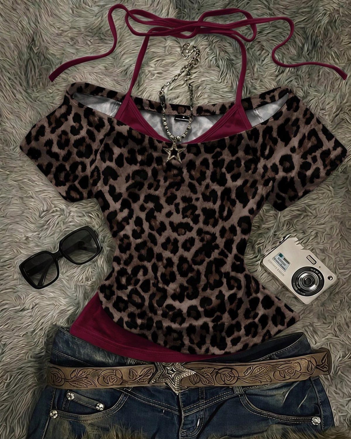 Leopard print halter top, denim shorts, sunglasses, and a digital camera on grey fur.